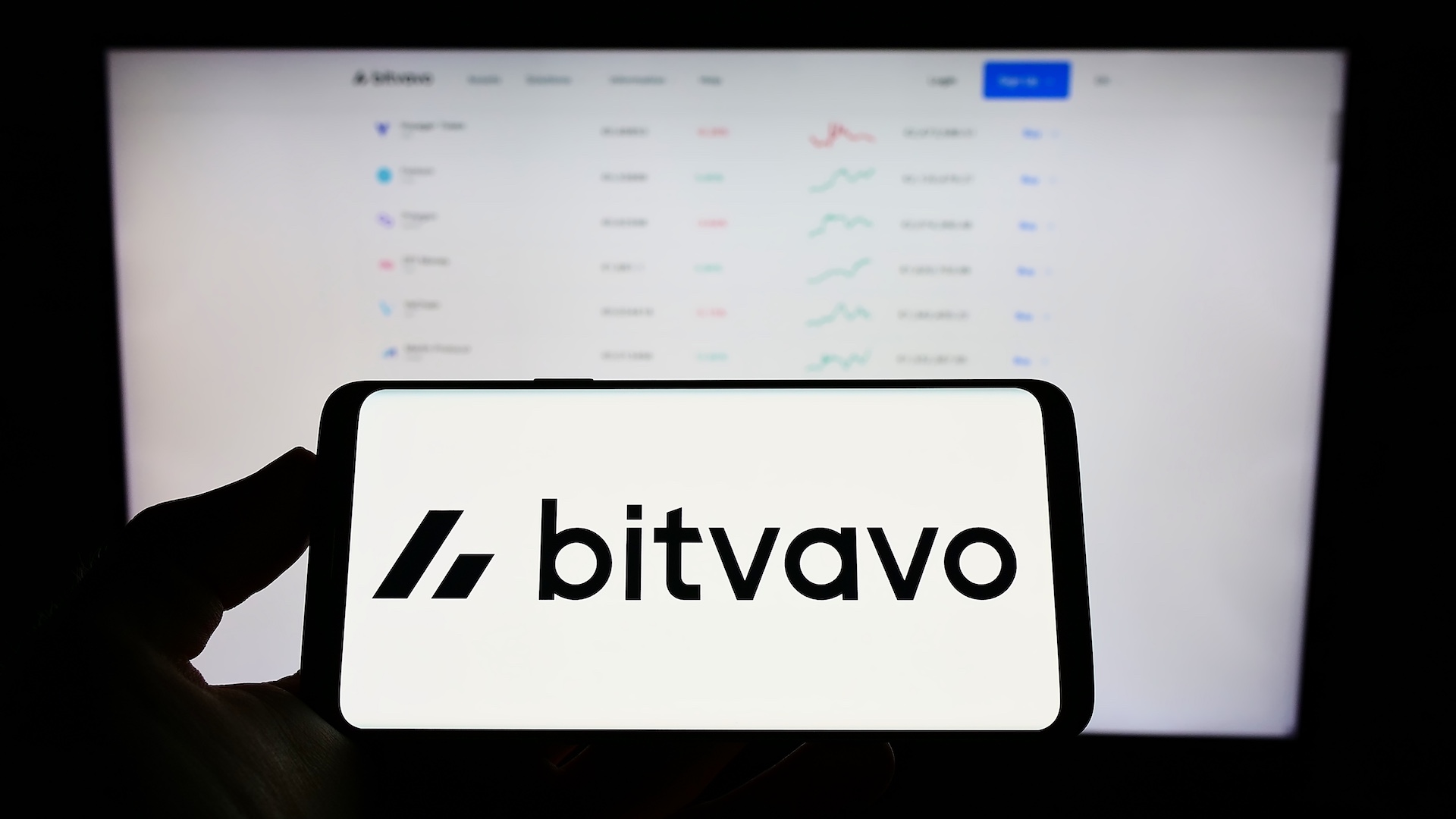 Bitvavo Logo auf Smartphone vor Handelsoberfläche – Symbolbild für Bitvavo Staking
