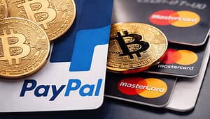 Dieses Bild zeigt das Paypal-Logo und eine Mastercard-Karte, mit Bitcoin-Münzen geschmückt. Es soll die Stablecoin-Adoption veranschaulichen.