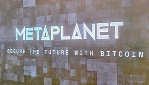 Das Bild zeigt das Logo von Metaplanet mit einer Aufschrift zu Bitcoin.