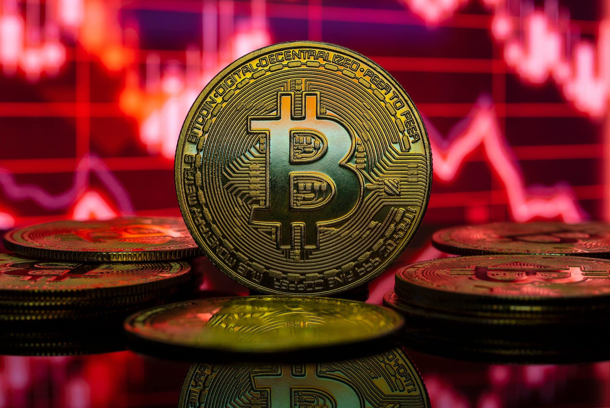 Eine Bitcoin-Münze vor rotem Hintergrund