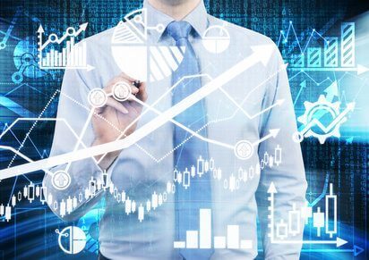 Analyst is drawing a financial calculations and predictions on the glass screen. Graphs, charts and arrows everywhere. A concept of forex market.