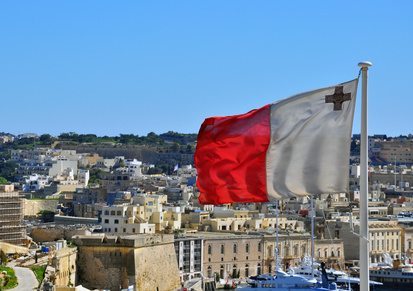 Maltese flag and cityscape