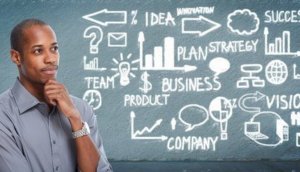 Black businessman looking business scheme.