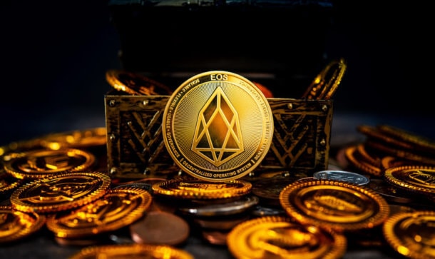 Mutmaßlicher EOS Scam konnte 52 Millionen US-Dollar erbeuten Man sieht eine Münze der Kryptowährung EOS in hellem Licht erstrahlen