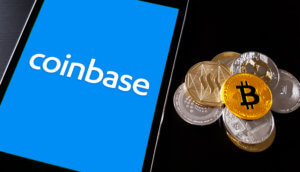 Smartphone mit Coinbase Logo udn Bitcoin-Münzen