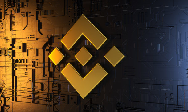 Binance US: Bitcoin-Börse ermöglicht Staking von Tezos (XTZ) Binance Logo in gelb auf Computerchip