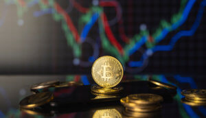bitcoin-münze steht hinter liegenden bitcoin-münzen vor einer chart