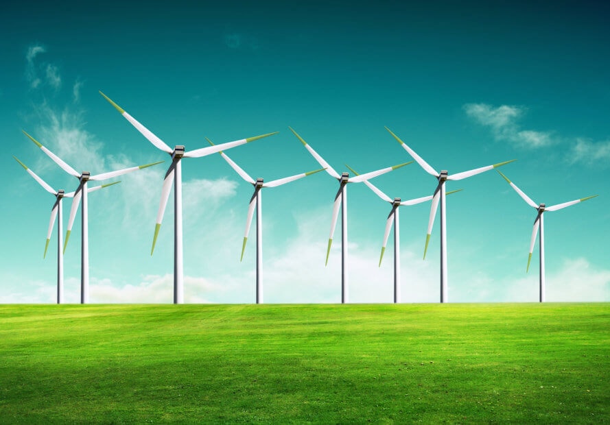 Blockchain-Lösung für die Stromversorgung von morgen weiße windräder auf einer grünen wiese vor einem blauen himmel mit wolken