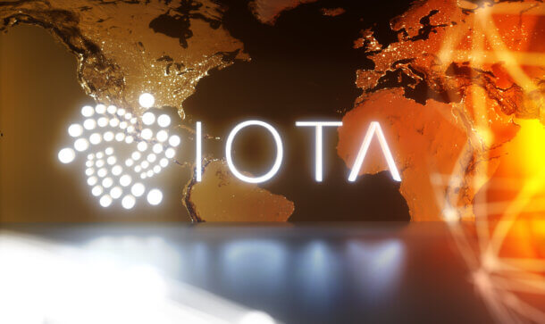 IOTA: Wie funktioniert eigentlich das Tangle? iota logo auf einem hintergrund, der ein stück der weltkarte zeigt