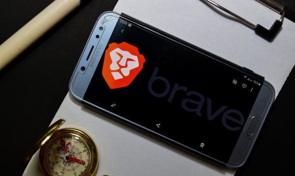 Brave begrüßt weiteren Kooperationspartner – BAT fünf Prozent im Plus Smartphone auf Klemmbrett mit Kompass, das Display ziert das Logo des Brave Browser