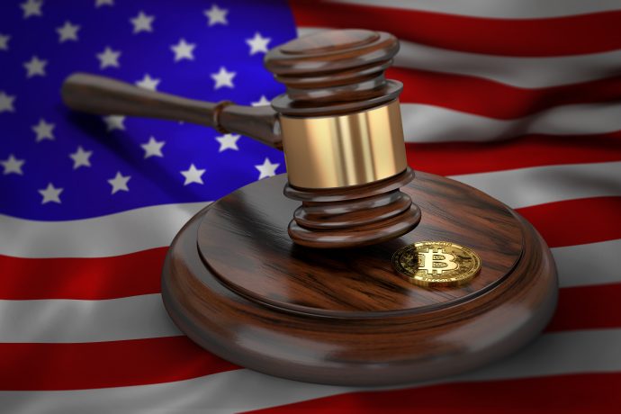 Bitcoin and judge gavel laying on flag of USA. Bitcoin legal situation in USA concept