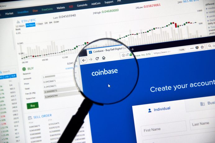 Coinbase cryptocurrency exchange website under magnifying glass