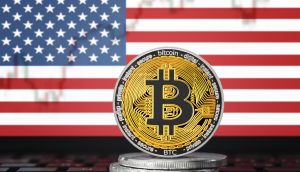 BITCOIN (BTC) cryptocurrency; coin bitcoin on the background of the flag of United States of America (USA)