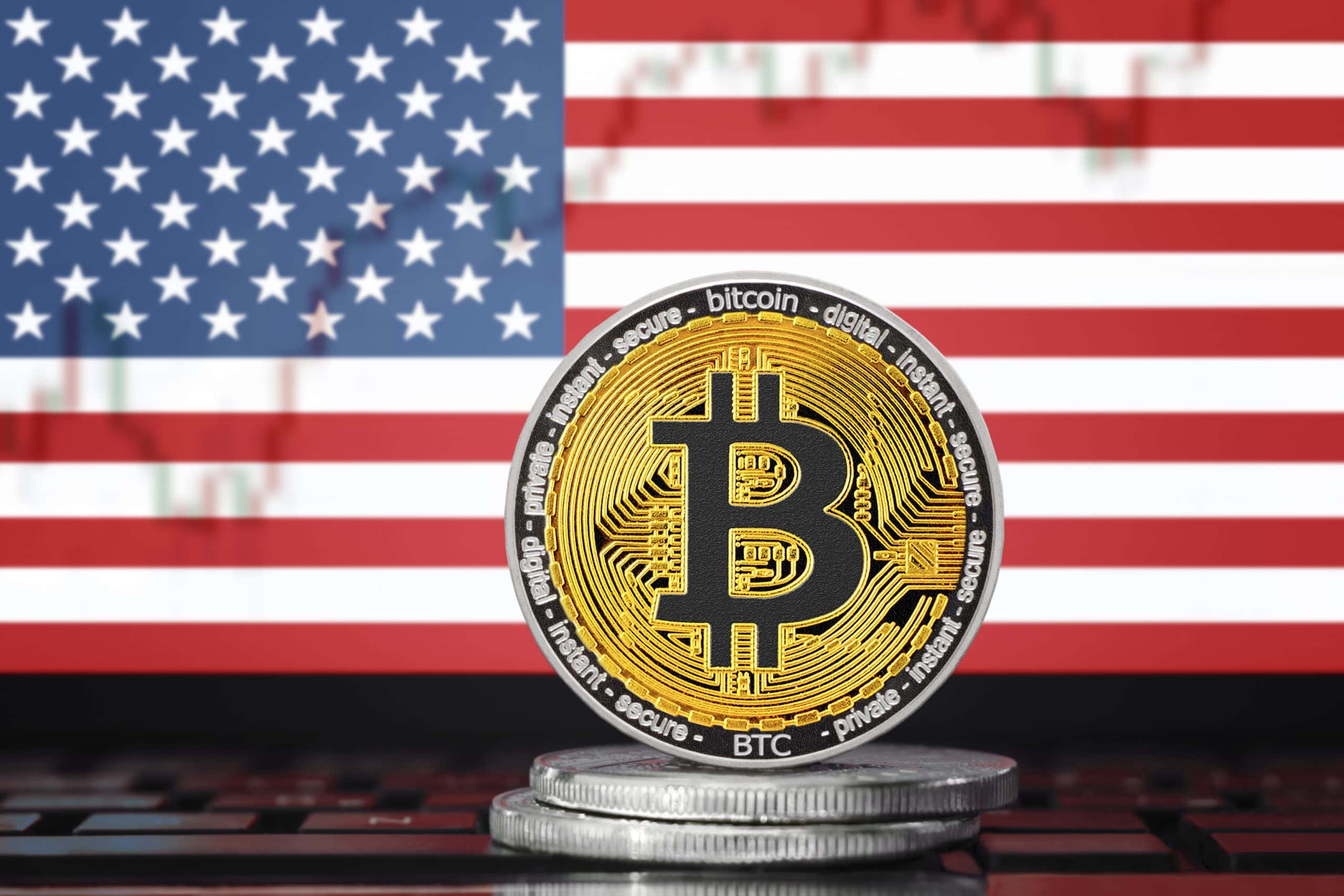 BITCOIN (BTC) cryptocurrency; coin bitcoin on the background of the flag of United States of America (USA)