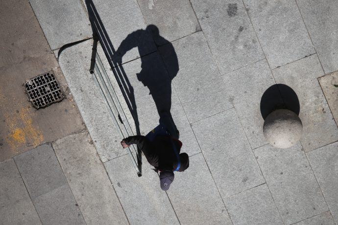 Shadows of people walking a street of the city