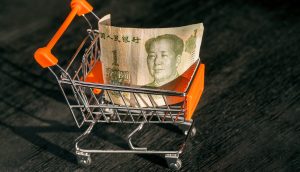 hopping cart with a paper banknote of One Chinese Yuan and face of leader Mao, as a symbol of the modern international economy