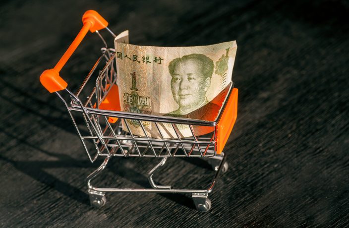 hopping cart with a paper banknote of One Chinese Yuan and face of leader Mao, as a symbol of the modern international economy