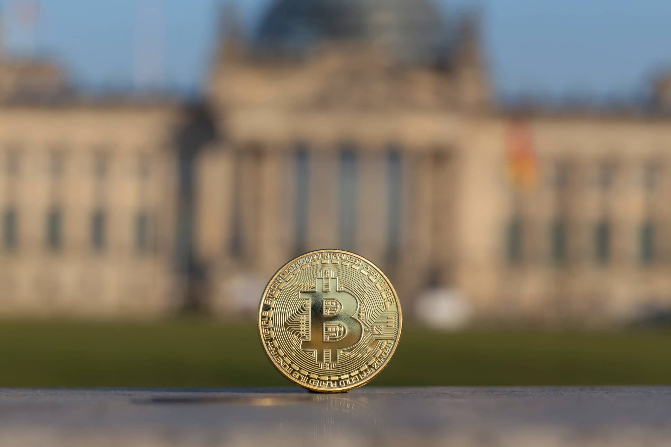 Ein Bitcoin steht senkrecht vor dem deutschen Bundestag.