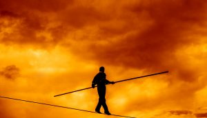 Wandering,Tightrope,Walker,Playing,On,Yellow,Sky,Background.,Silhouette,Of