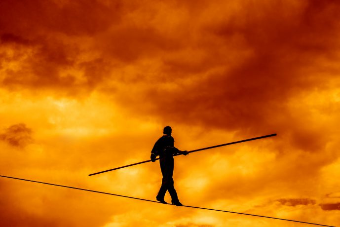 Wandering,Tightrope,Walker,Playing,On,Yellow,Sky,Background.,Silhouette,Of