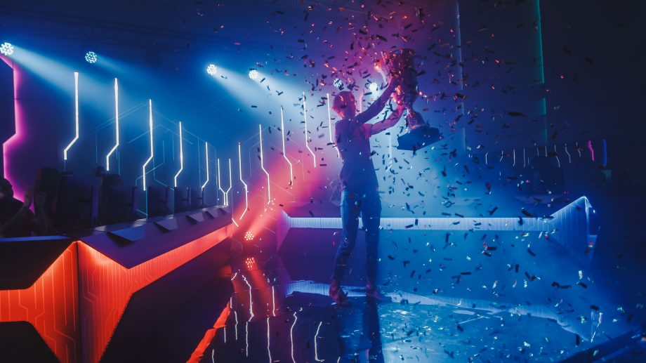 E-Sport meets Krypto: Coinbase kooperiert mit Berliner Organisation Ein Gewinner eines eSports Turnieres hält einen Pokal nach oben und freut sich
