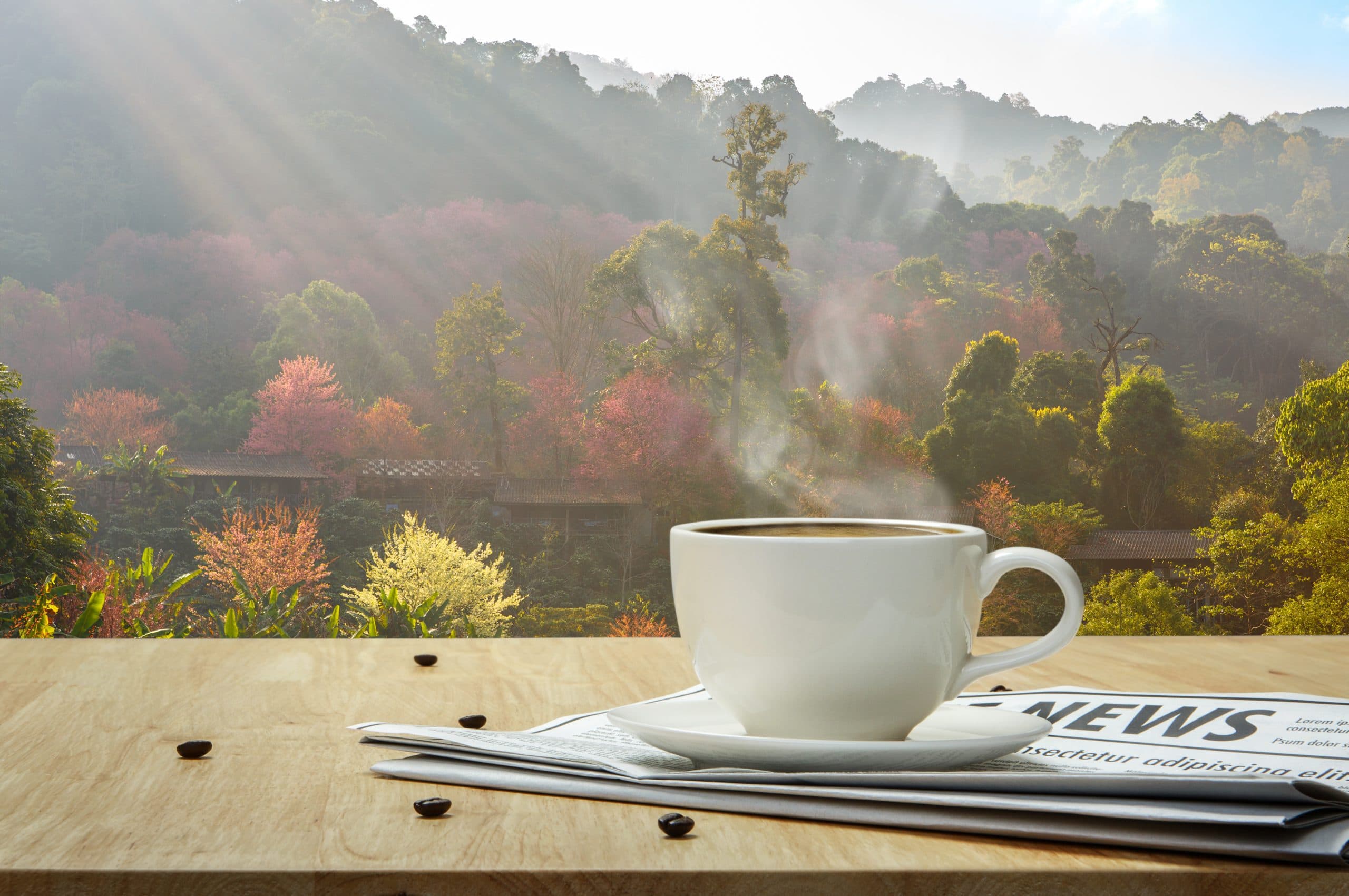 Kaffee und Nachrichten liegen auf Tisch