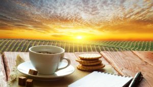Getränk und Tasse stehen vor malerischem Hintergrund