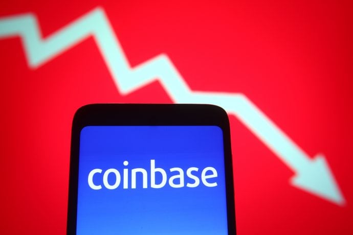 Coinbase-Logo auf einem Smartphone vor rotem Hintergrund