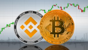 Münzen von Bitcoin und Binance Coin vor einem Chart