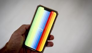 Eine Hand hält ein Smartphone mit vertikalen Regenbogenstreifen und dem Wort „bunq“ in der Mitte, wodurch das farbenfrohe Branding der Bunq-Banking-App hervorgehoben wird.
