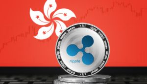 Eine Ripple-Münze (XRP) steht auf gestapelten Münzen vor einem Monitor, der die Flagge von Hongkong und ein schwaches Finanzdiagramm zeigt und den wachsenden Einfluss von Ripple Labs in Asien und das Interesse von XRP-Fonds symbolisiert.