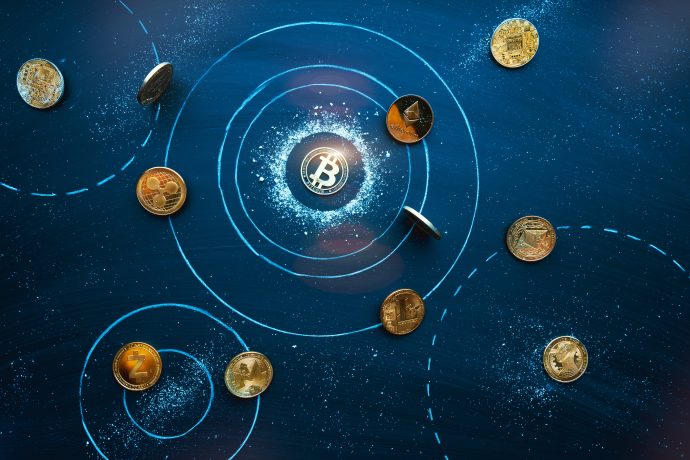Verschiedene Kryptowährungsmünzen, darunter Bitcoin, sind auf einer dunkelblauen Oberfläche mit eingezeichneten orbitähnlichen Pfaden und kreisförmigen Mustern angeordnet.