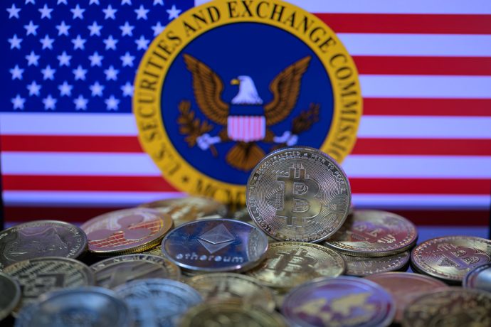 Ein Haufen Bitcoin-Münzen vor dem Logo der SEC