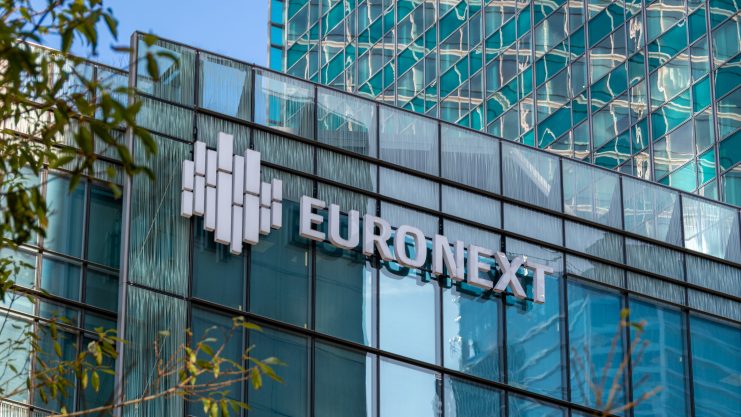 Gläserne Gebäudefassade mit dem Euronext-Logo und -Namen an prominenter Stelle, mit Spiegelungen der umliegenden Strukturen und Hinweisen auf den wachsenden Einfluss von Bitcoin in der Finanzwelt.