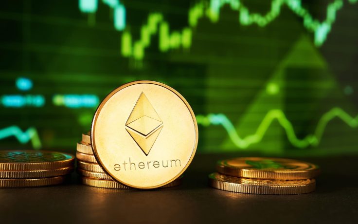 Ethereum vor dem Ausbruch? Ein Stapel Ethereum-Münzen wird vor einem digitalen Bildschirm gezeigt, der grüne Finanzcharts und Ethereum-Kursgrafiken anzeigt.