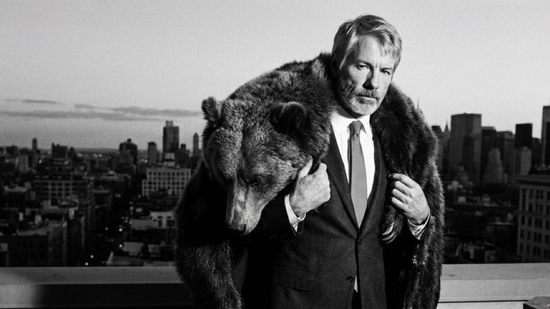 Michael Saylor auf einem schwarz-weiß Bild mit einem erlegten Bären über seinen Schultern