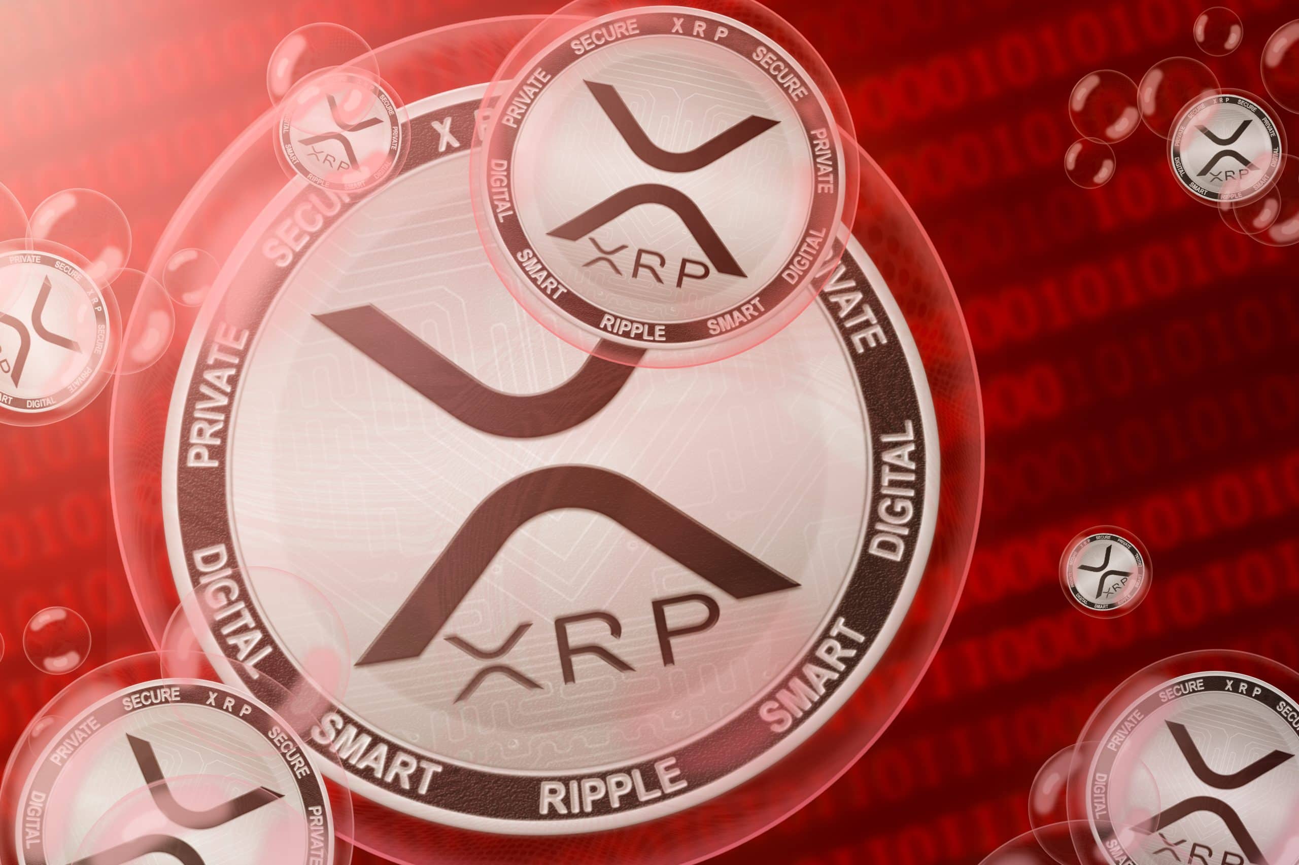 XRP-Münze vor roten Zahlen im Hintergrund