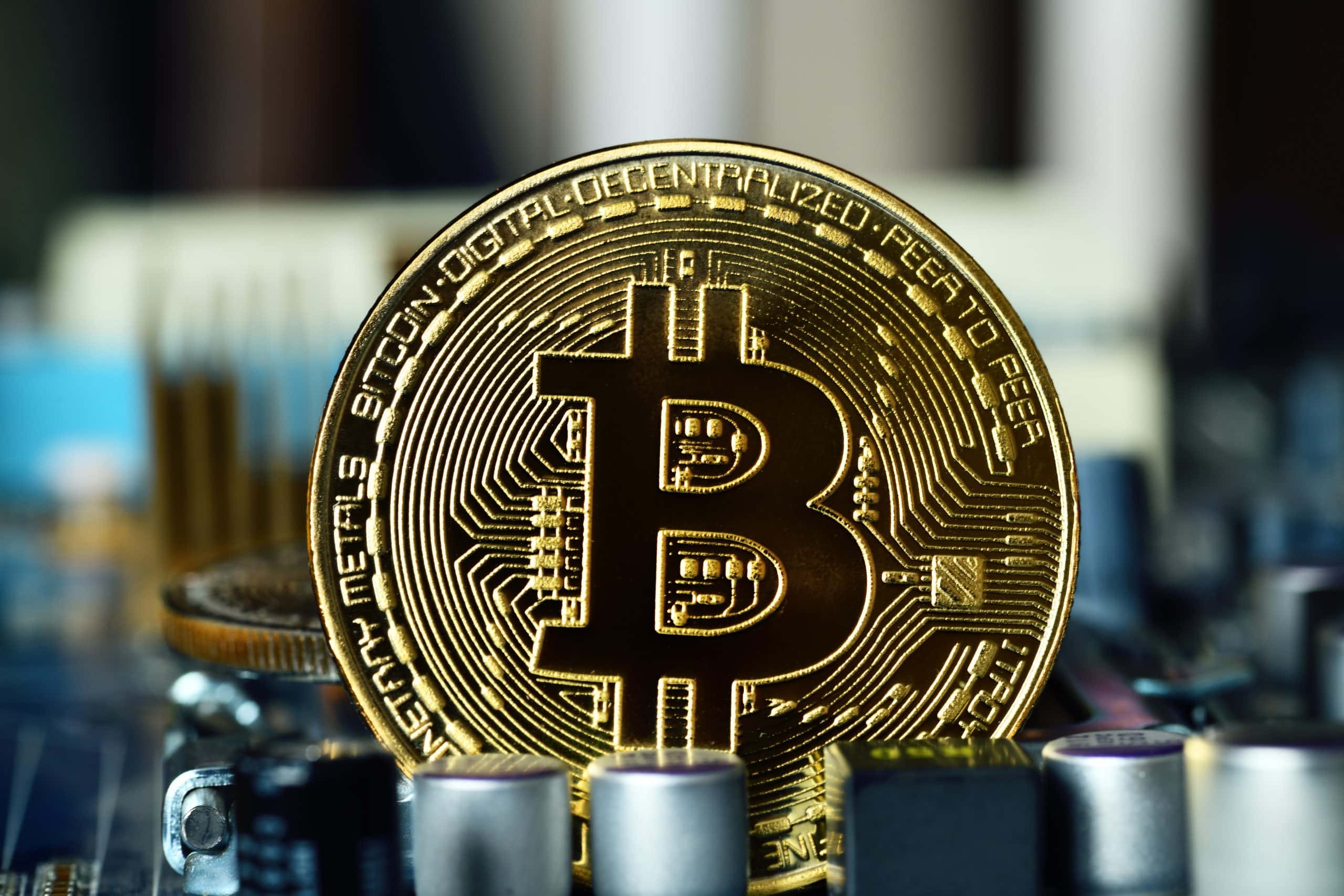 Eine Bitcoin-Münze liegt auf einem Computerchip