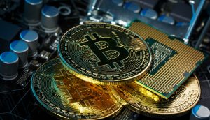 Drei Bitcoin-Münzen liegen auf den Sicherheitselementen einer Hardware Wallet.