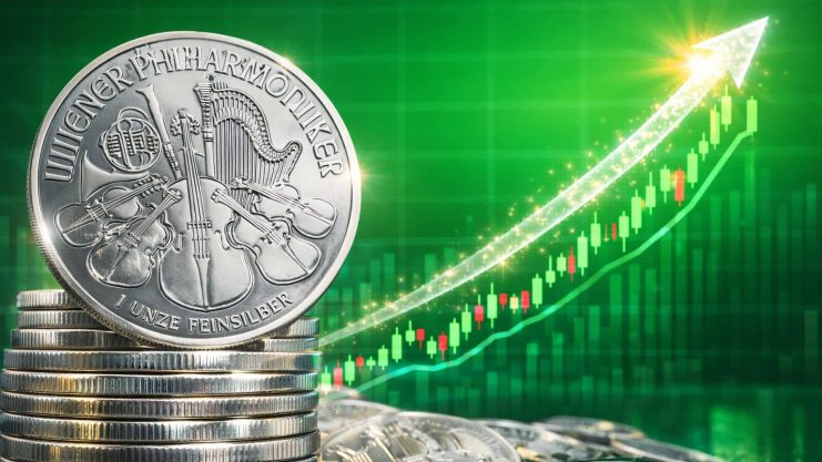 Silber steigt unaufhörlich weiter Silbermünzen vor einem aufsteigenden grünen Chartbild