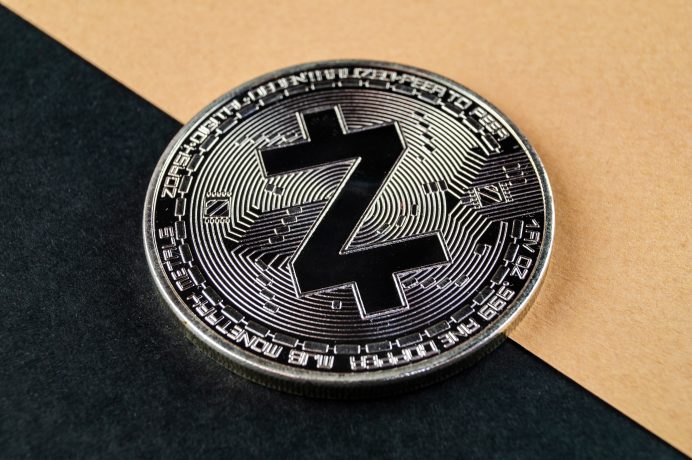 Eine Zcah-Münze liegt auf einem schwarz/gelben Hintergrund
