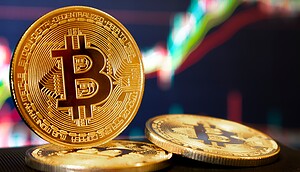 Eine Bitcoin-Münze vor einem Chart-Hintergrund