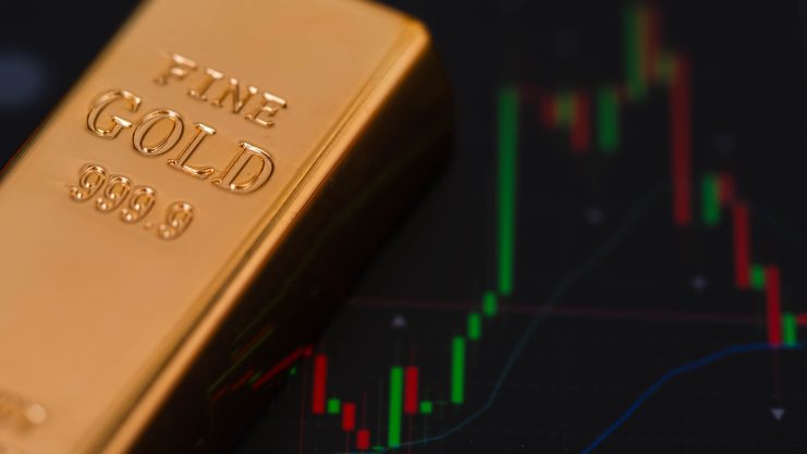 Goldbarren vor Chart