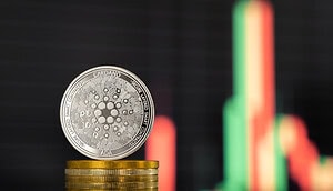 Eine Cardano-Münze vor einem Kurschart.