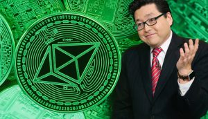 Ein Mann im Anzug mit roter Krawatte und Brille steht rechts im Bild und gestikuliert mit einer Hand, während im Hintergrund große, grün leuchtende Ethereum-Münzen mit technischen Mustern zu sehen sind.