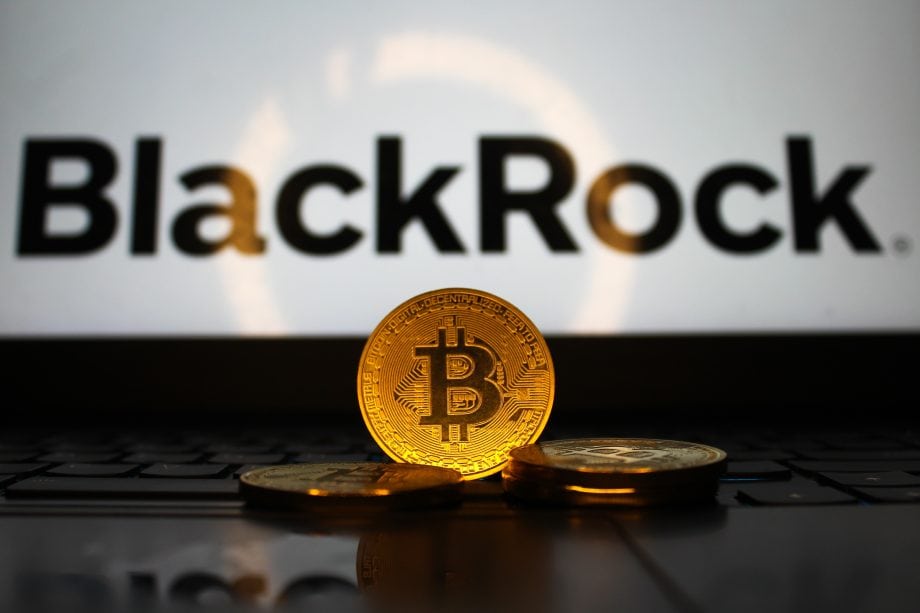 Das Bild zeigt eine Bitcoin-Münze vor dem BlackRock-Logo