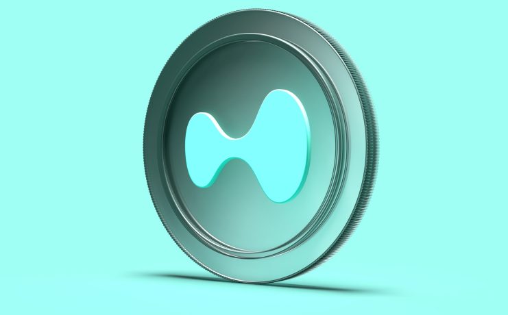 Ein stilisiertes, türkisfarbenes Coin-Logo von Hyperliquid ist vor einem einfarbigen Hintergrund zu sehen.