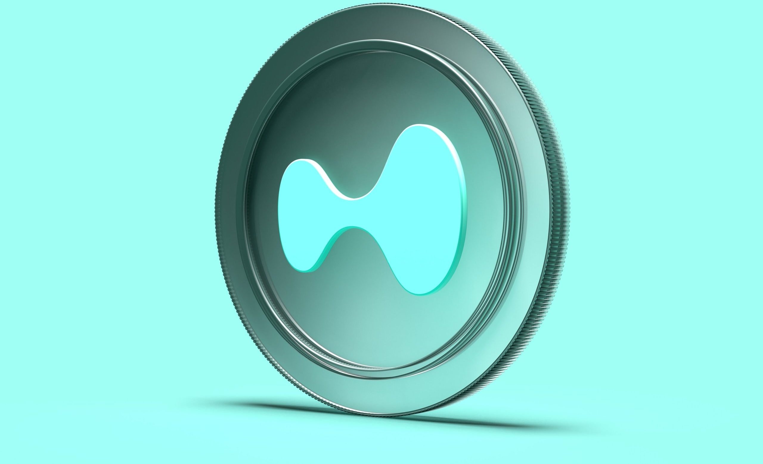 Ein stilisiertes, türkisfarbenes Coin-Logo von Hyperliquid ist vor einem einfarbigen Hintergrund zu sehen.