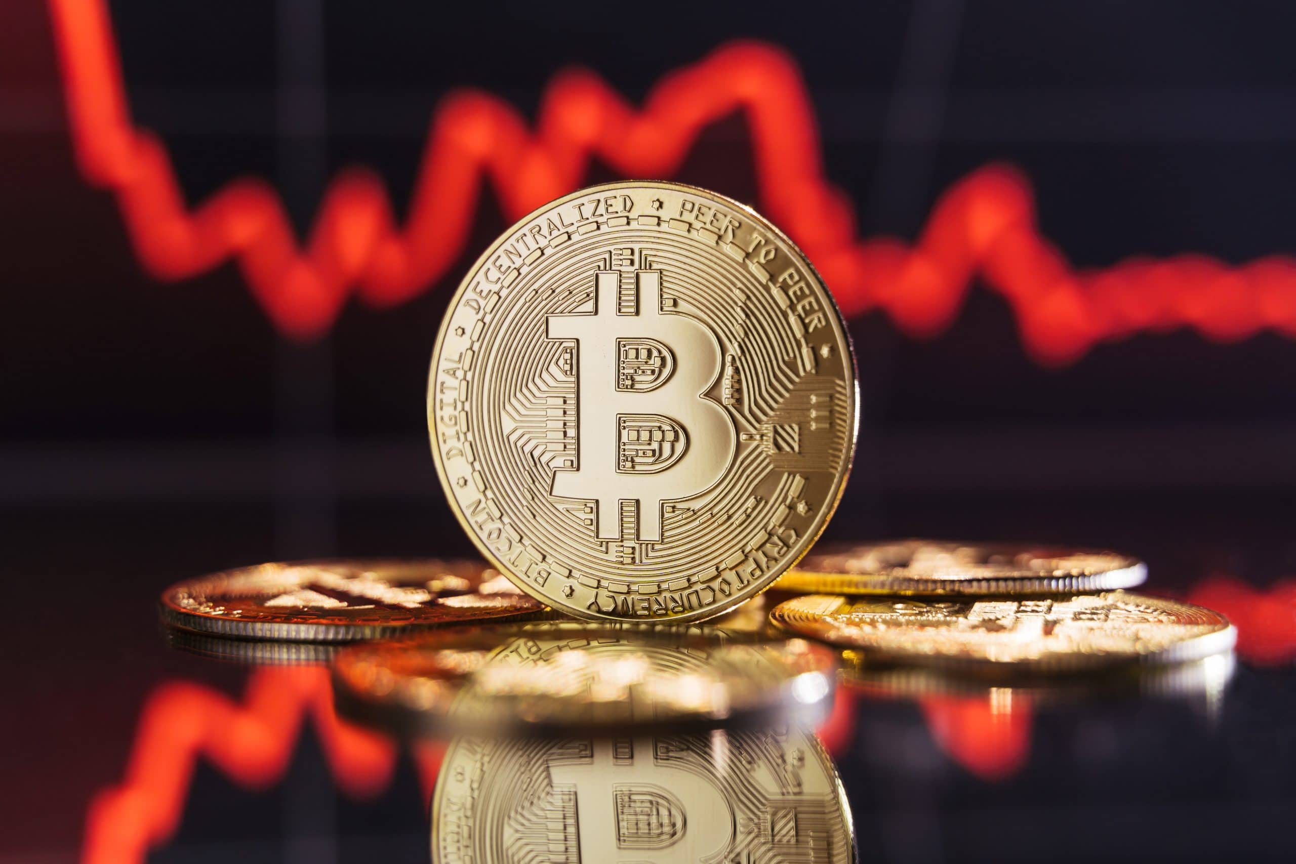Eine Bitcoin-Münze vor einem Chart