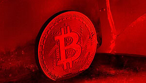 Eine rot angeleuchtete Bitcoin-Münze